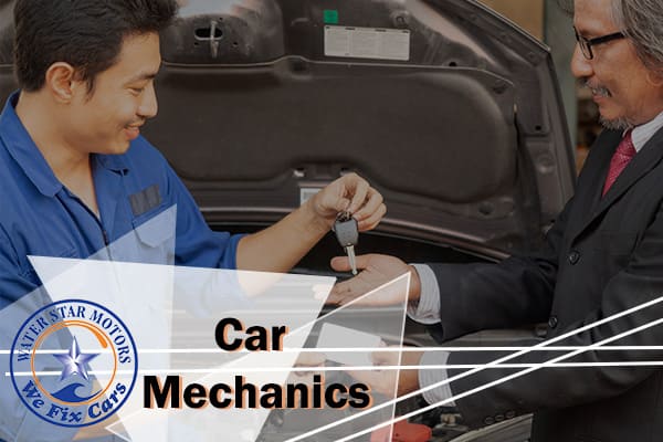 A car mechanic returning the car keys to a satisfied customer